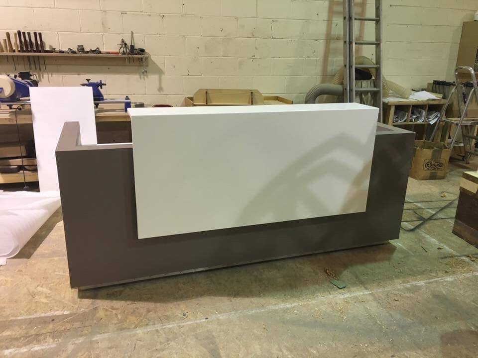 Reception desk with mauve and white finish