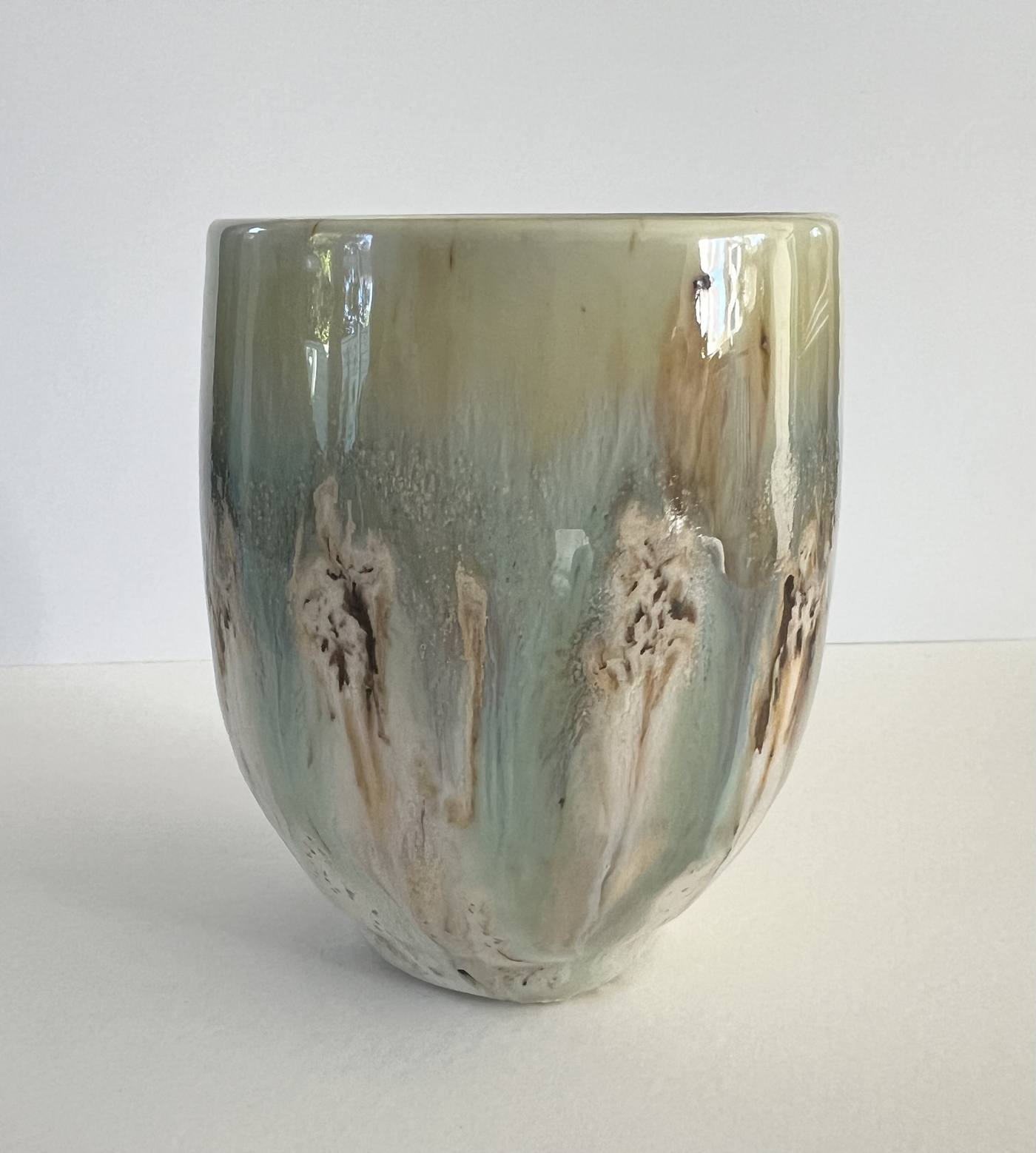 Green and cream drip glaze vessel