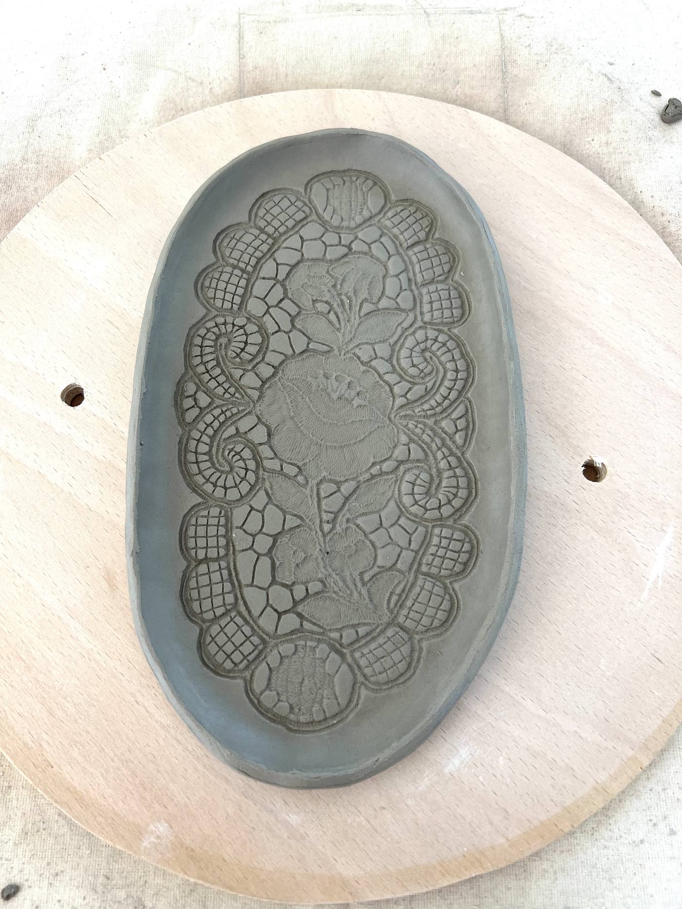 Oval clay tray with lace-textured pattern